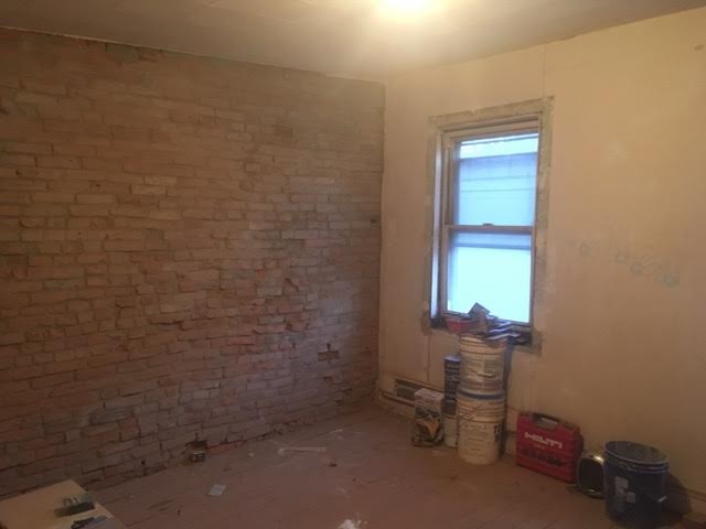 #1 Untreated Exposed Brick Wall (Front Bedroom)