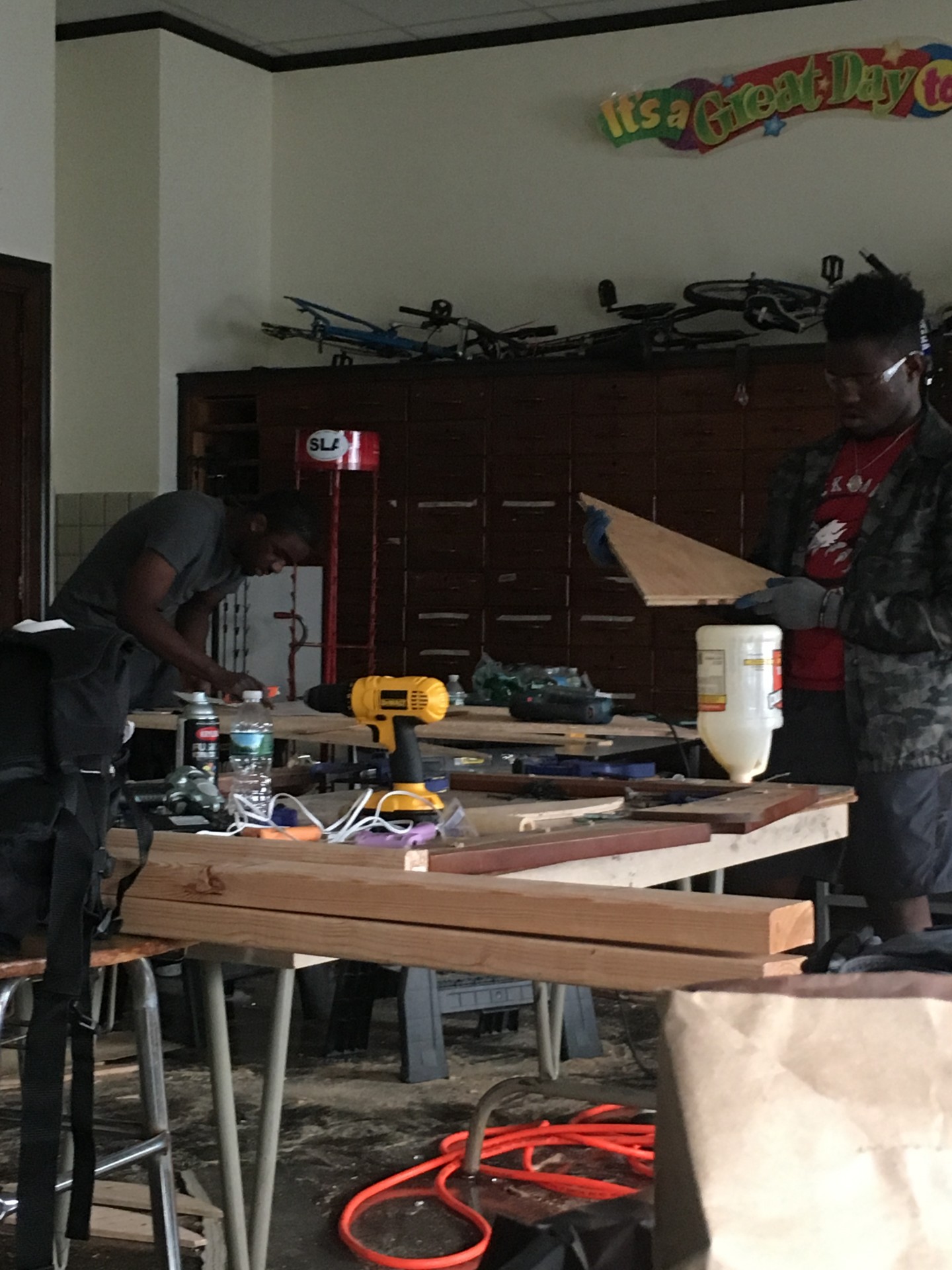 Charles and Abdul cutting out the rocket nozzle and stencils